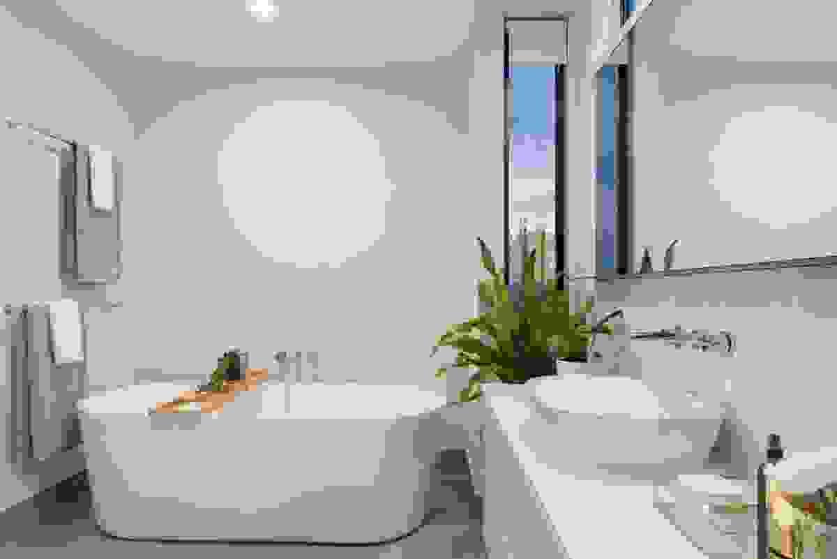 Custom built modern bathroom, with bowl shaped sink and bath tube enhanced by plants located in Roanoke VA