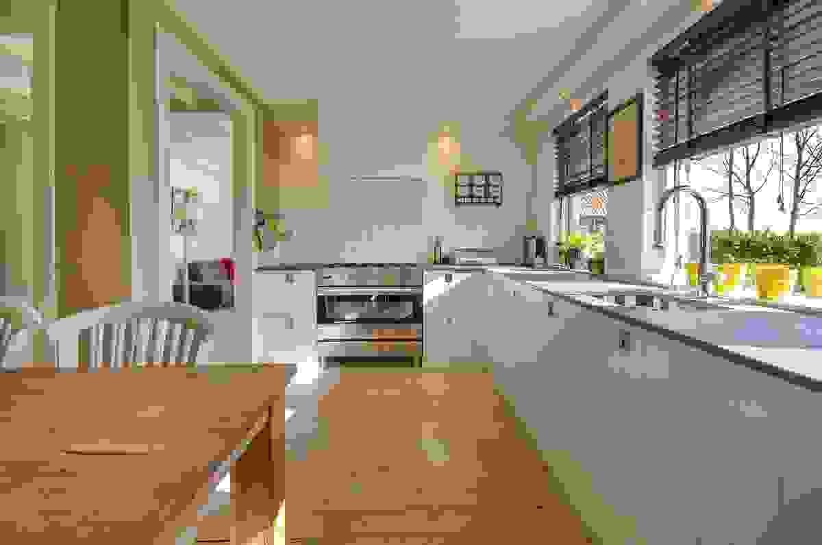 A culinary kitchen design with lots of counter tops and natural lights custom built white modern cabinets in Roanoke VA.