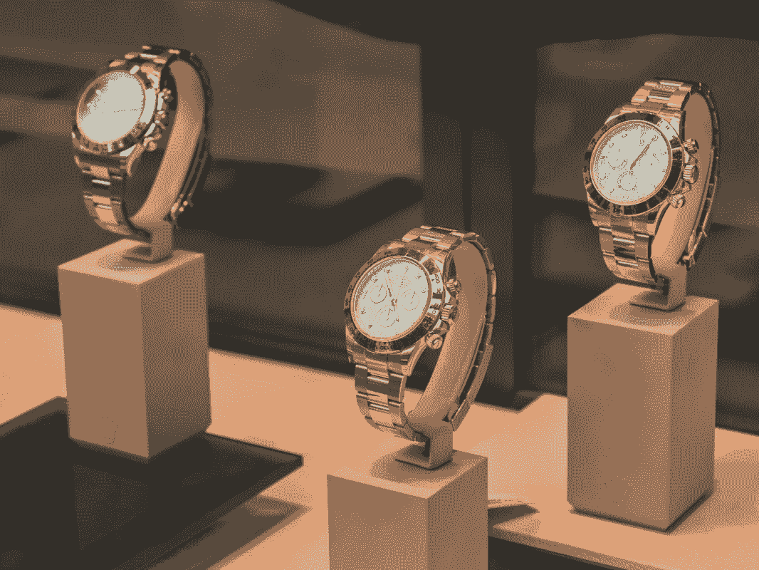 Three wristwatches displayed on stands Three wristwatches displayed on stands