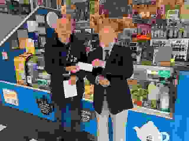 Dougie Dickenson of The Izaak Walton Lodge of Freemasons handing a cheque to the RNLI.
