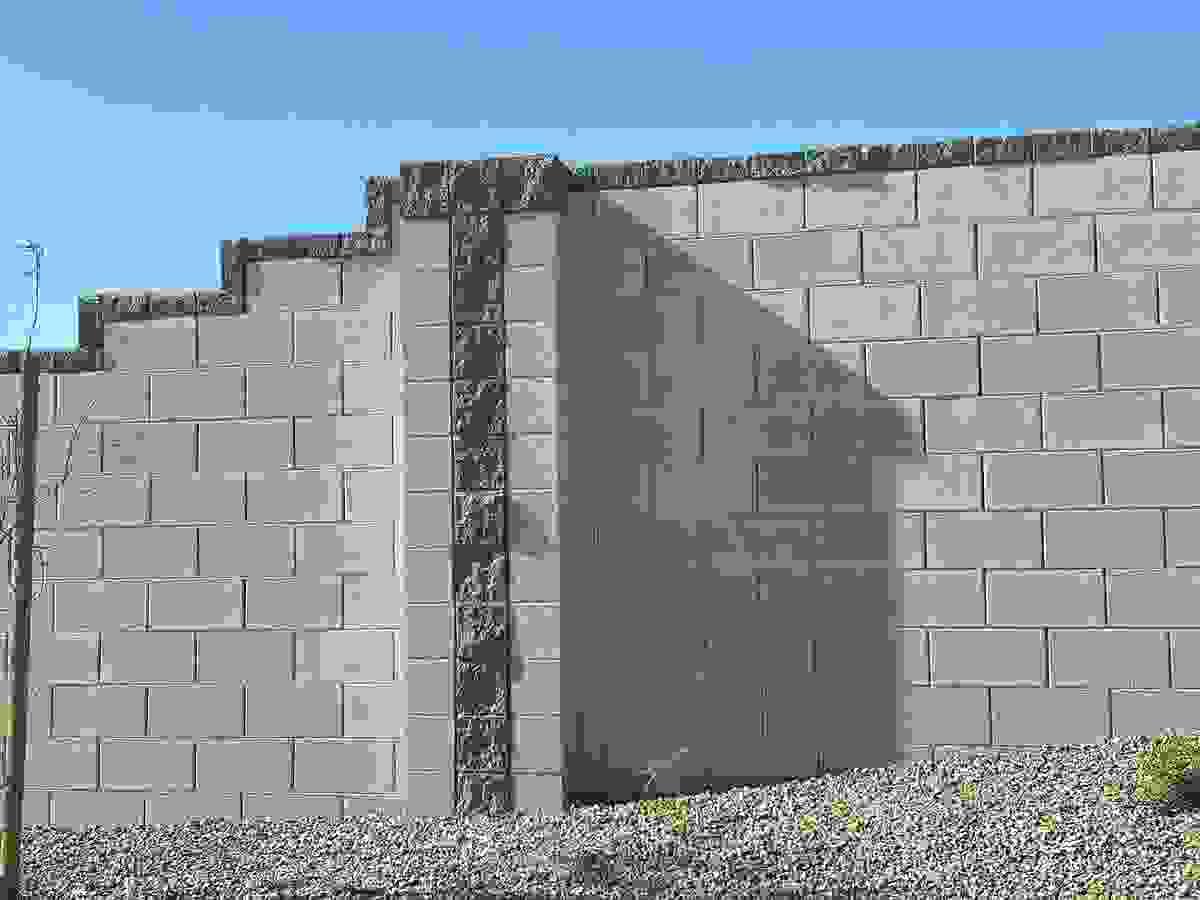 Grey concrete block wall with custom block design accents in dark grey in Avondale, AZ