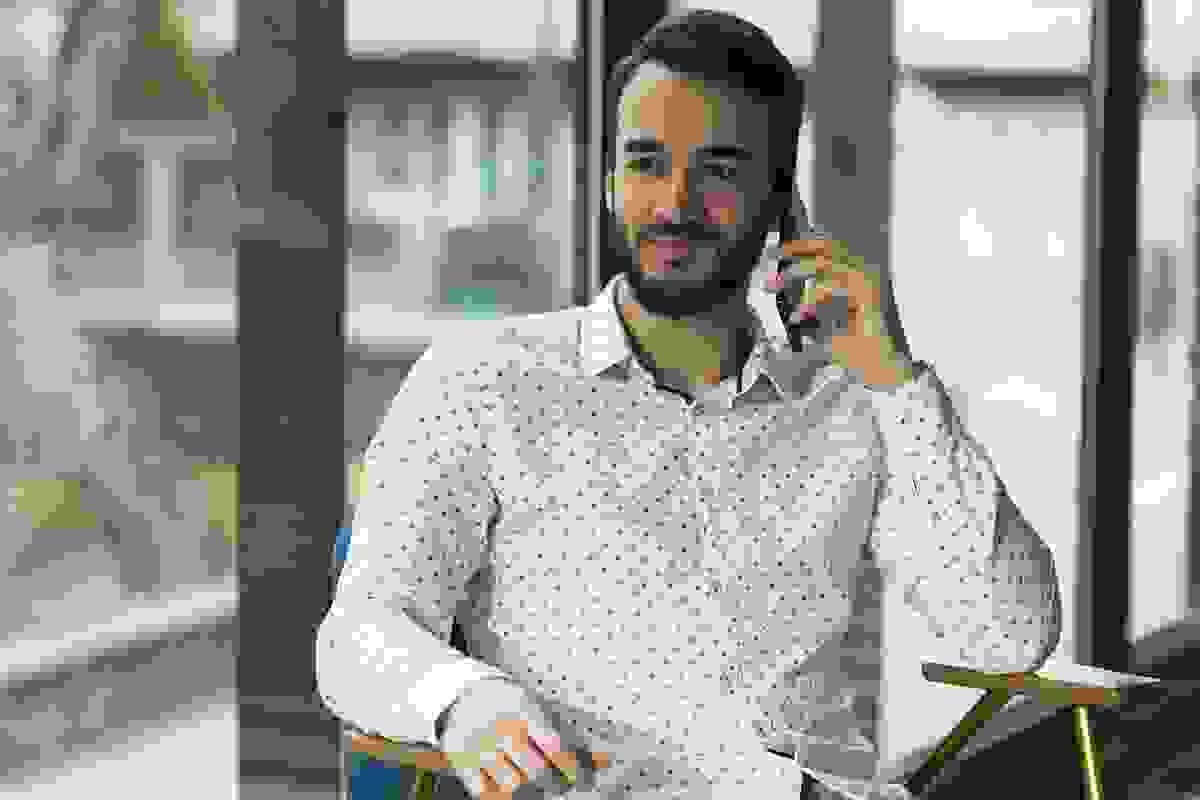 Man on phone taking details for a free quote for a block wall 