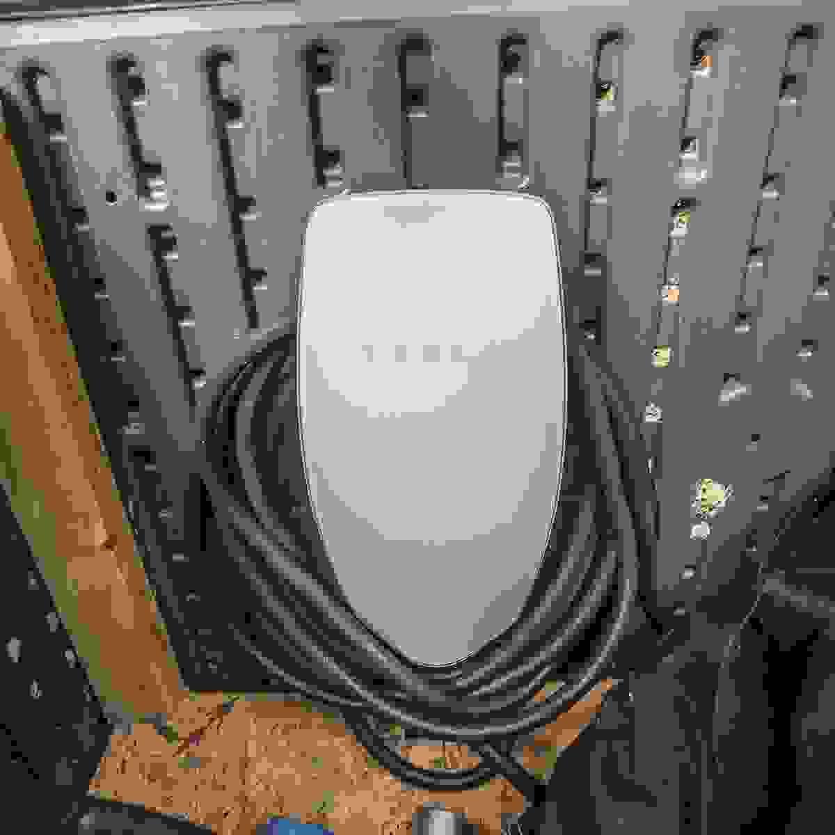 Residential EV Charger In Garage Plugged Up To Car Residential EV Charger In Garage Plugged Up To Car