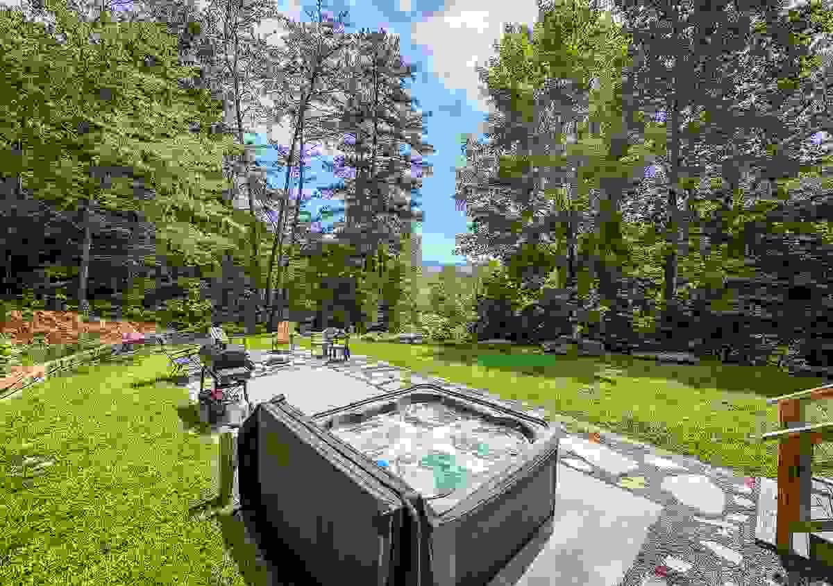 Hot Tub on backyard concrete slab with grill and firepit Hot Tub on backyard concrete slab with grill and firepit