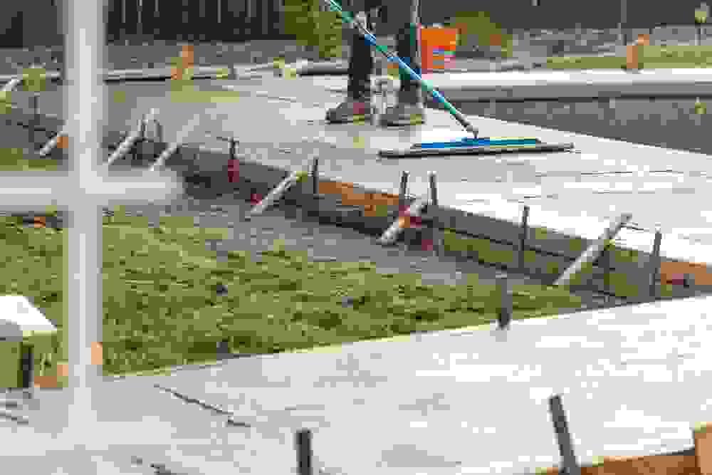 smoothing concrete walkway around pool with tool smoothing concrete walkway around pool with tool