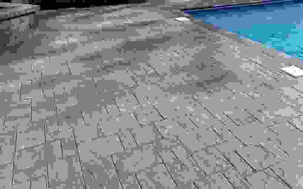 grey and tan stamped concrete pattern by pool to mimick pavers grey and tan stamped concrete pattern by pool to mimick pavers