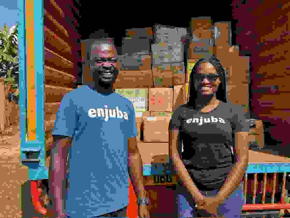 Our Chief Literacy Officer, William Mukisa (in blue) upon receiving the books.