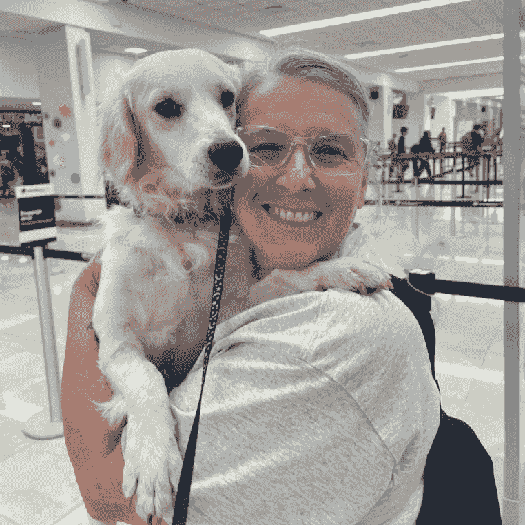 Woman holding a dog at the airport before travel. Woman holding a dog at the airport before travel.