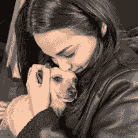 Adopter cuddling a newly rescued dog in its forever home. Adopter cuddling a newly rescued dog in its forever home.