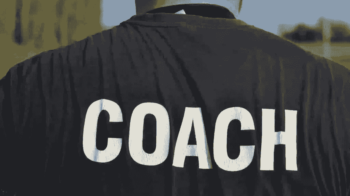 A coach leading a youth baseball team. A coach leading a youth baseball team.