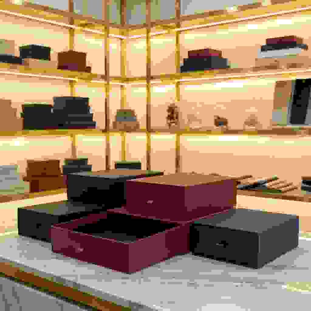 Handmade drawer-style rigid boxes with sliding tray and ribbon pull on marble counter. Handmade drawer-style rigid boxes with sliding tray and ribbon pull on marble counter.