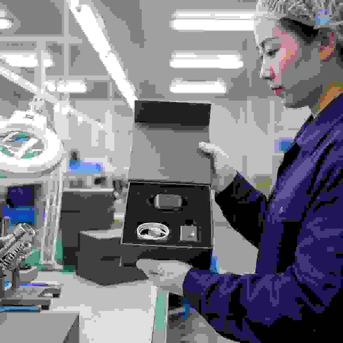 Chinese factory QC scene showing a rigid box with precision-cut EVA insert for electronics. Chinese factory QC scene showing a rigid box with precision-cut EVA insert for electronics.