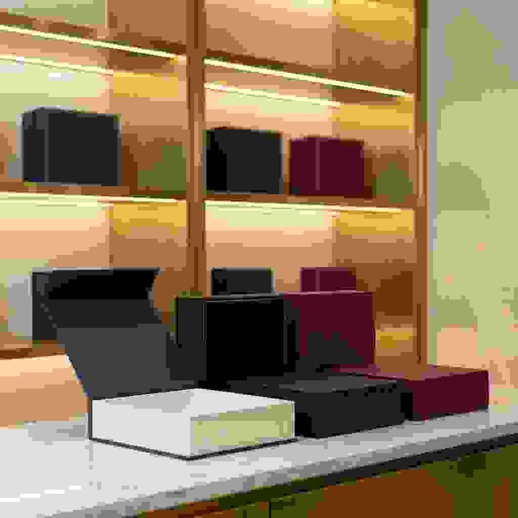 Handmade magnetic closure gift boxes on marble countertop in luxury packaging showroom. Handmade magnetic closure gift boxes on marble countertop in luxury packaging showroom.