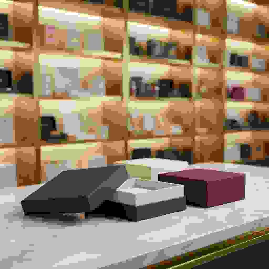 Classic two-piece lid and base rigid boxes on a marble counter, with one opened to show the interior. Classic two-piece lid and base rigid boxes on a marble counter, with one opened to show the interior.