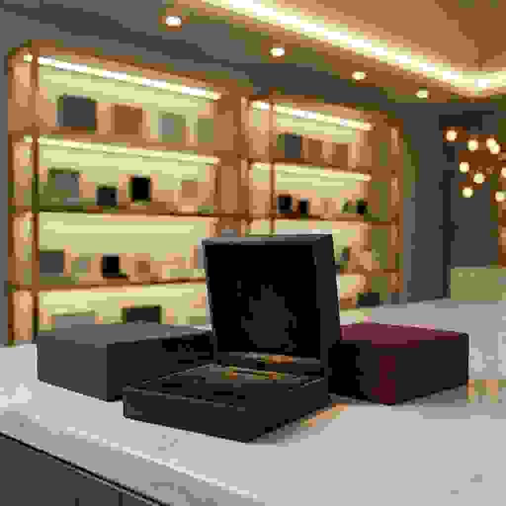 Luxury rigid box with a velvet flocked insert, shown open to highlight the soft texture and cutouts. Luxury rigid box with a velvet flocked insert, shown open to highlight the soft texture and cutouts.