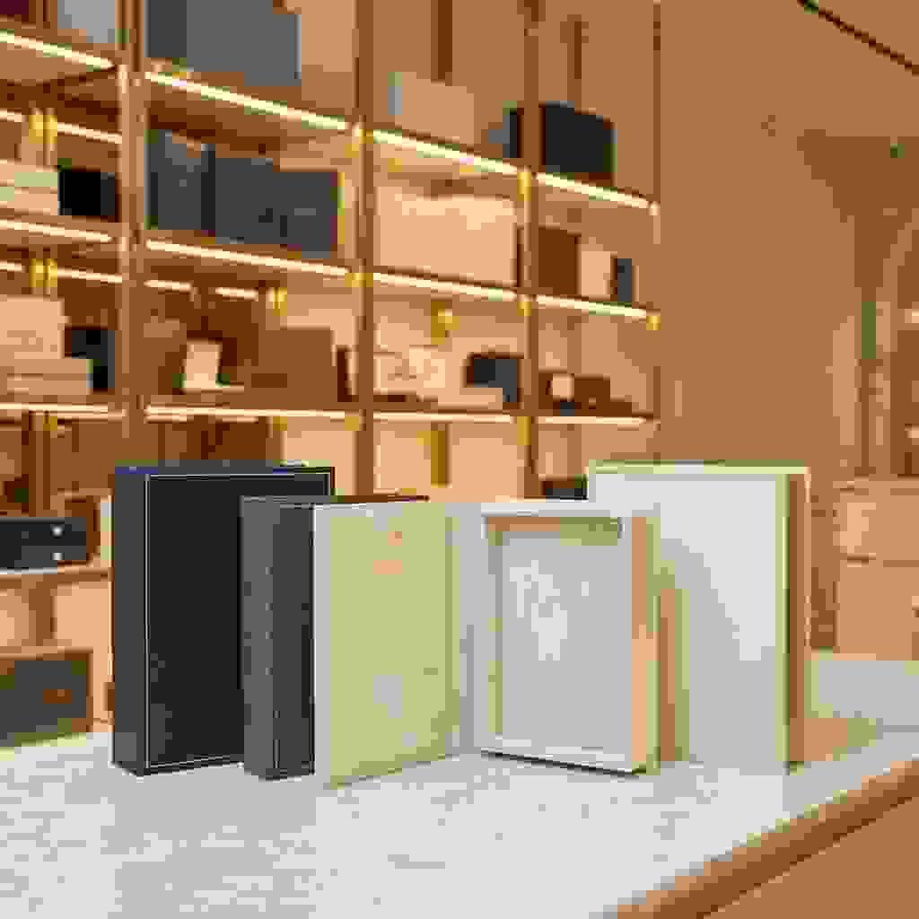 Book-style handmade rigid boxes with hinged opening in a premium showroom setting. Book-style handmade rigid boxes with hinged opening in a premium showroom setting.