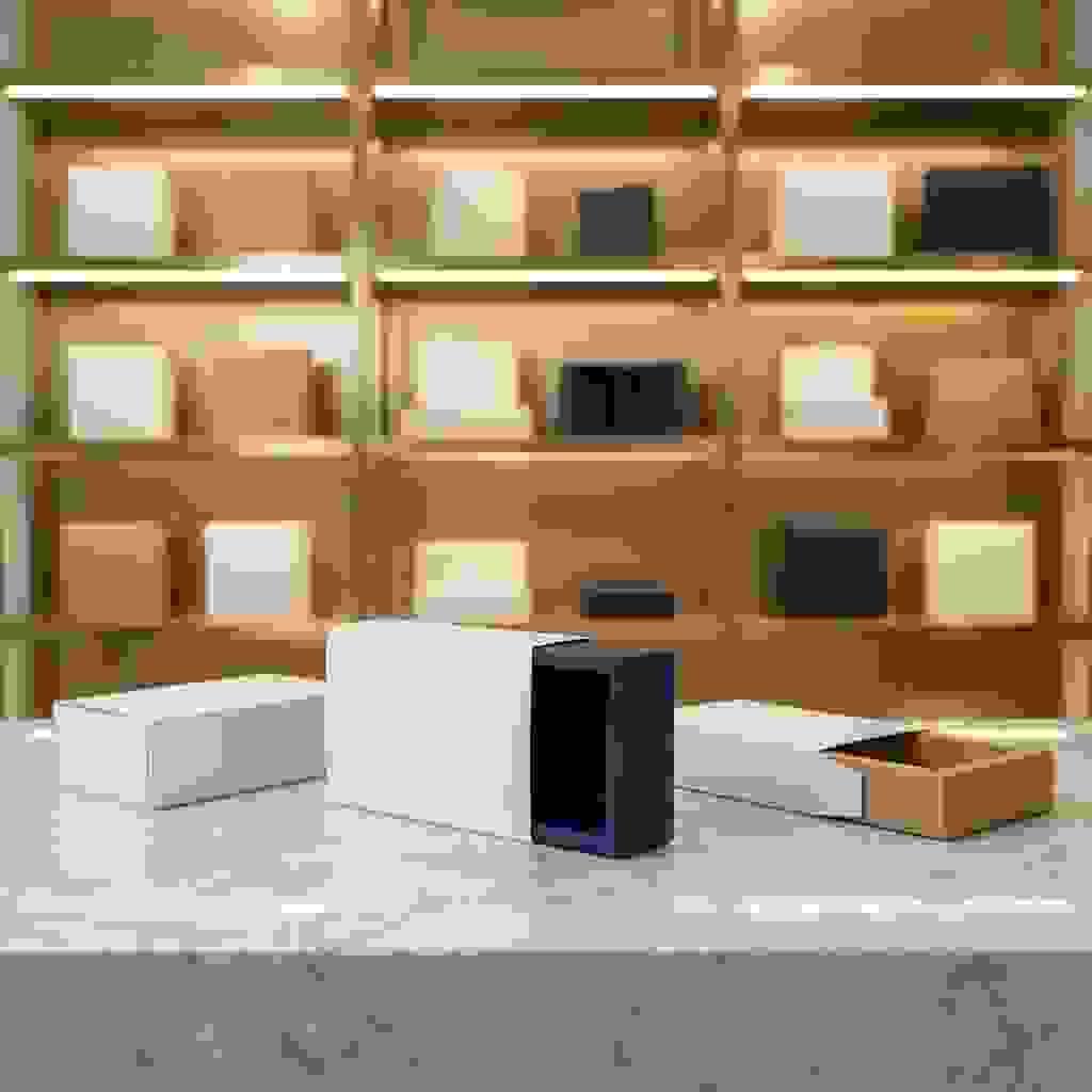 Folding carton sleeve with inner tray on marble counter, sleeve partially slid off, warm showroom background. Folding carton sleeve with inner tray on marble counter, sleeve partially slid off, warm showroom background.