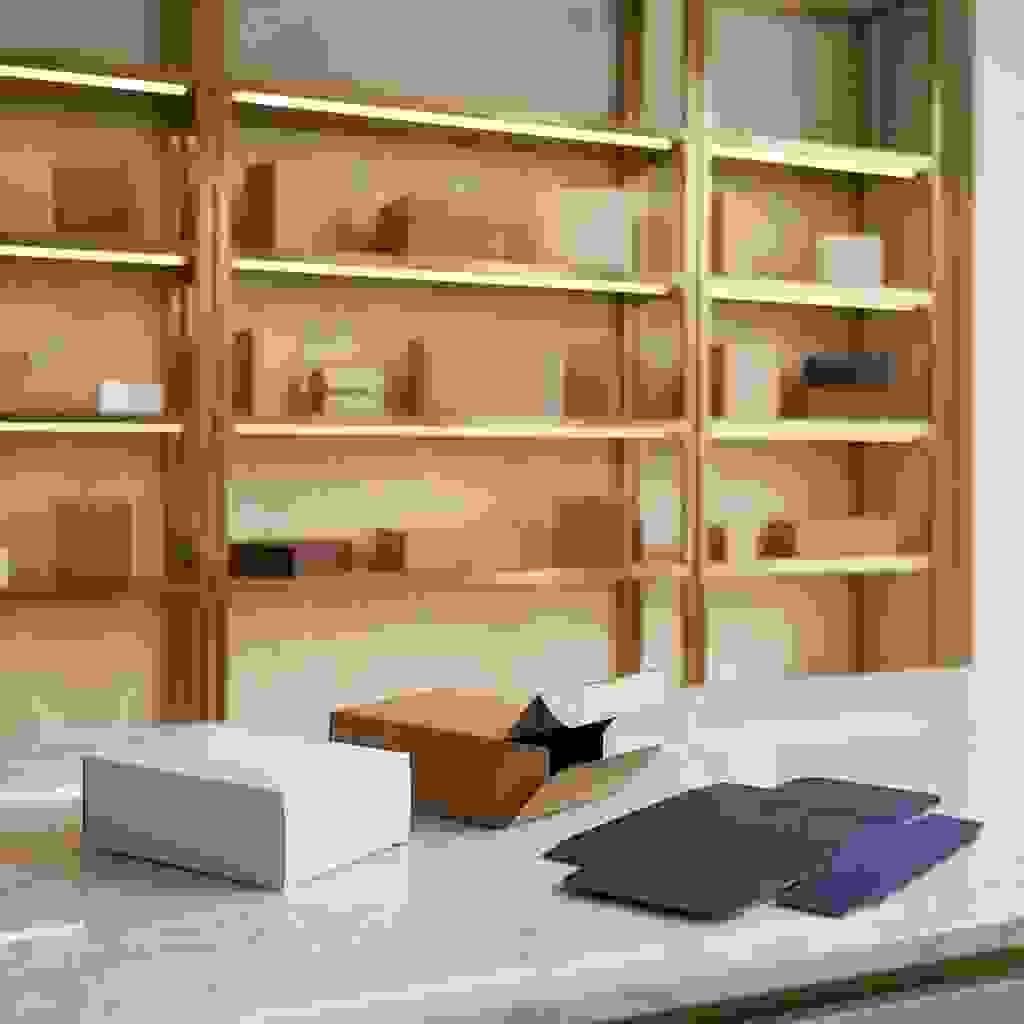 Reverse tuck end folding cartons on marble countertop, one open showing tuck flaps, luxury showroom background. Reverse tuck end folding cartons on marble countertop, one open showing tuck flaps, luxury showroom background.