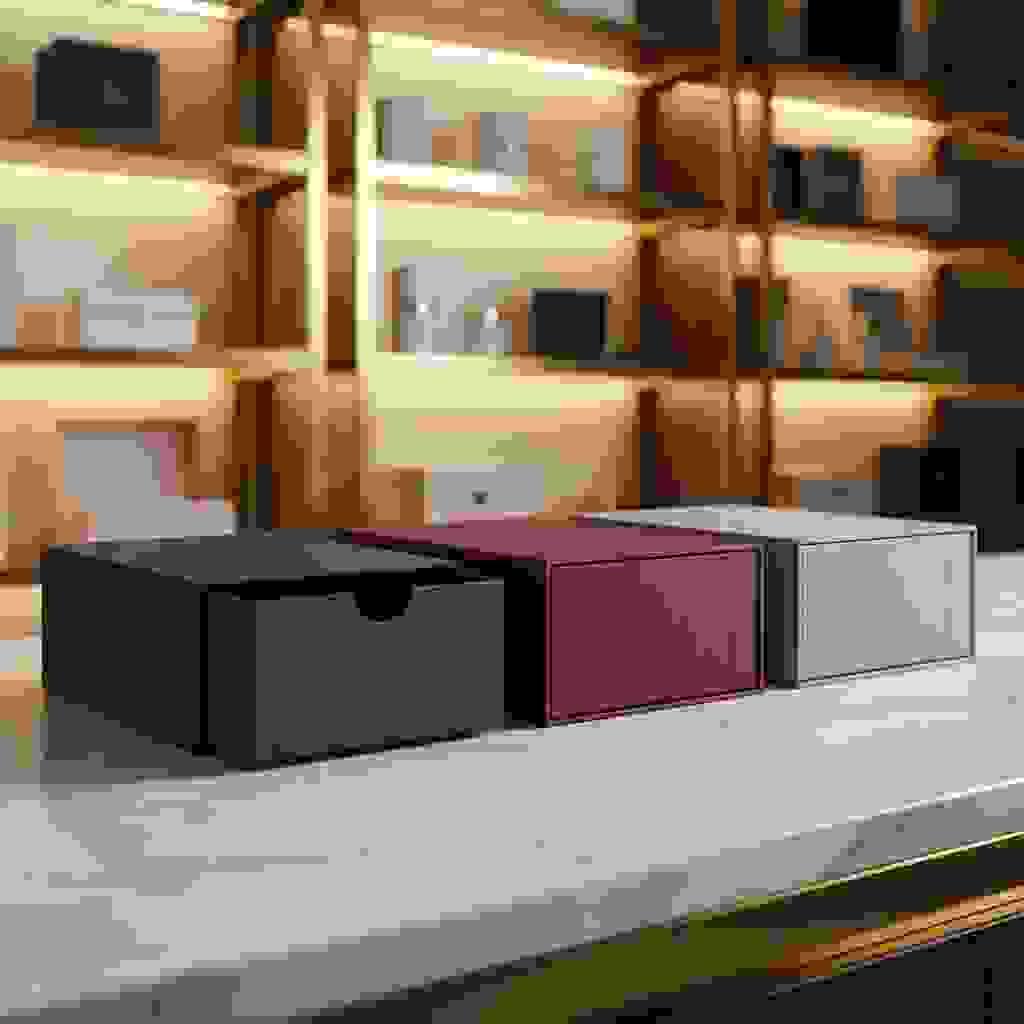 Three finger notch drawer boxes with a visible notch detail and one partially opened slide-out tray. Three finger notch drawer boxes with a visible notch detail and one partially opened slide-out tray.