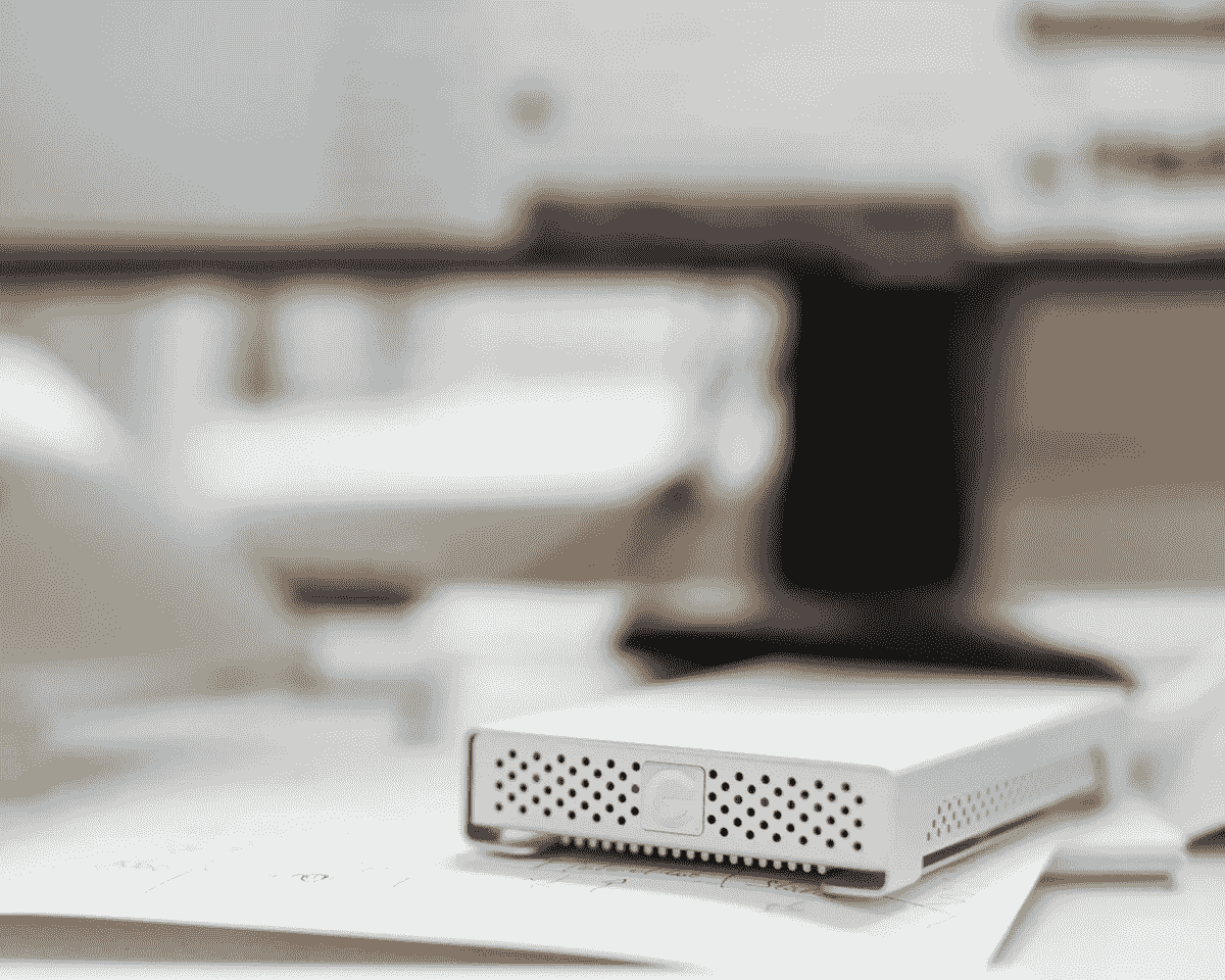 Photo of an external hard drive on a desk next to a description of the measurement and design service. Photo of an external hard drive on a desk next to a description of the measurement and design service.
