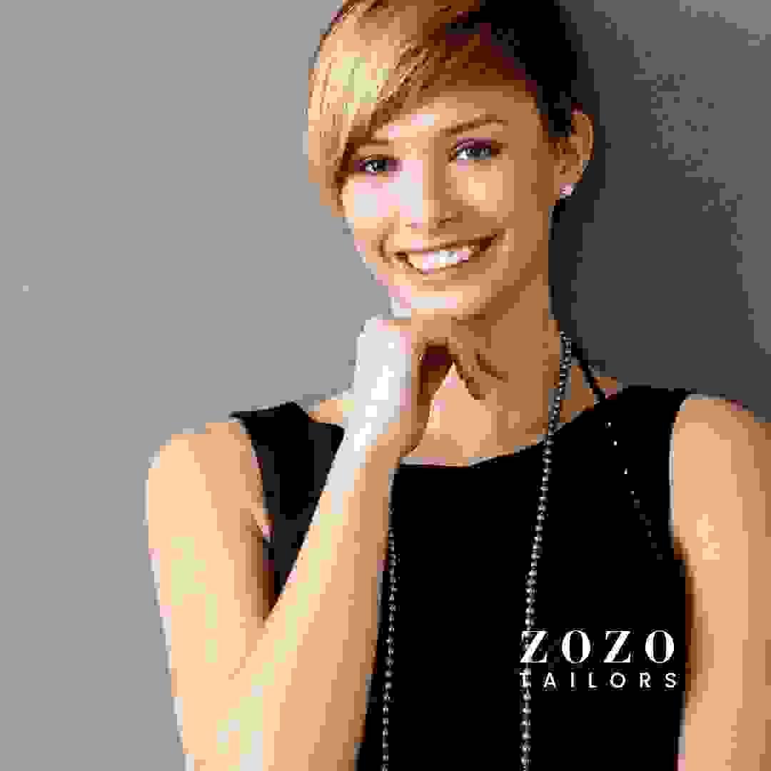 Young woman in a tailored black shift dress with pearls — blending classic simplicity with individual elegance.