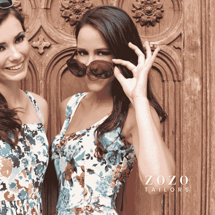 image of two friends on vacation in their tailor-made sundresses, which are in fabrics of similar colours but different  patter