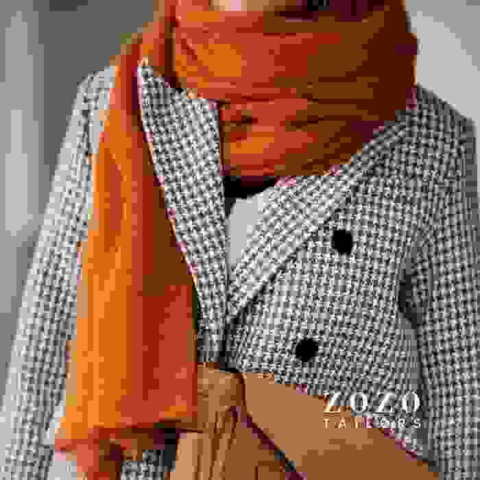 Double breasted tailored coat in a houndstooth fabric for timeless elegance and warmth.