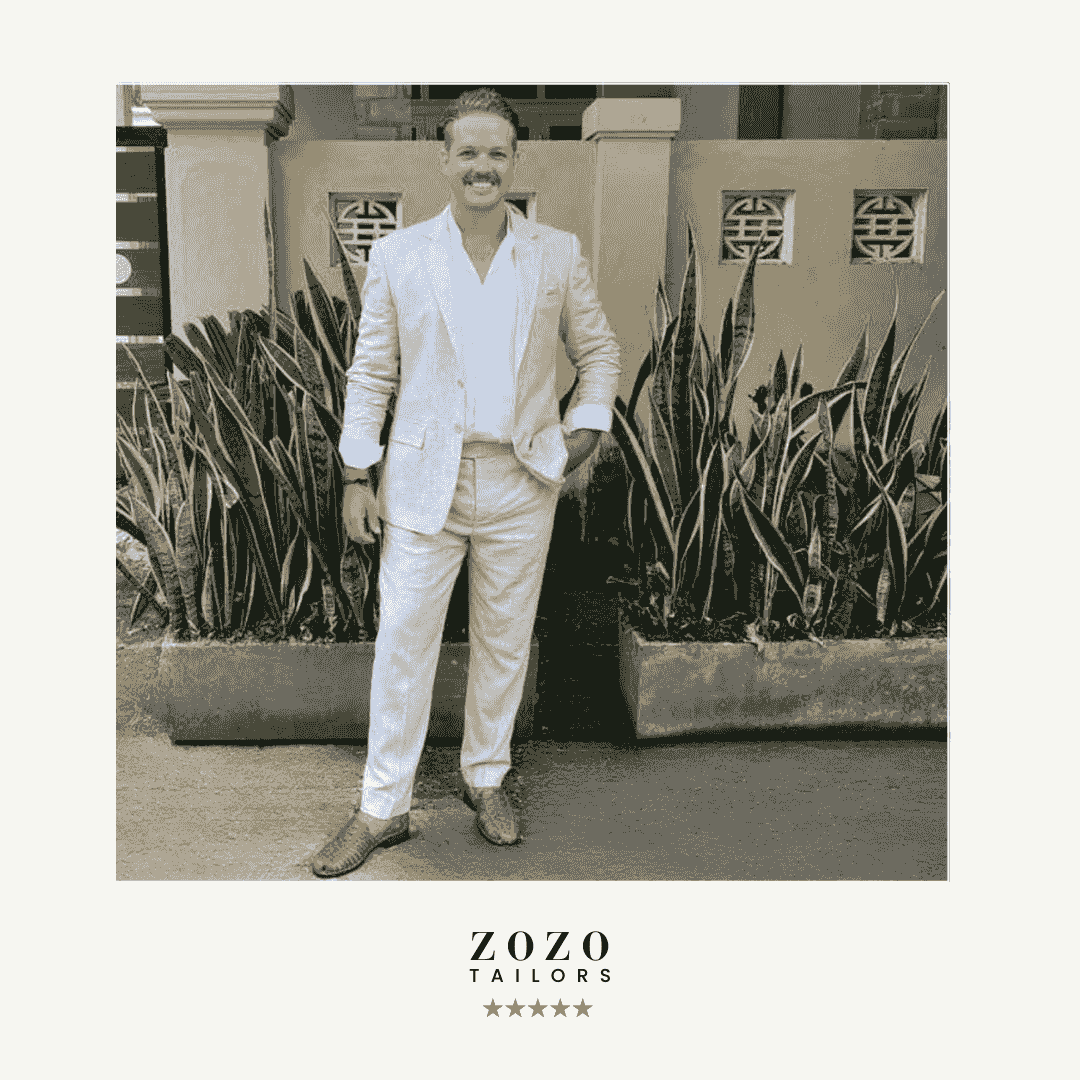 Person wearing a light linen suit for warm-weather tailoring Person wearing a light linen suit for warm-weather tailoring