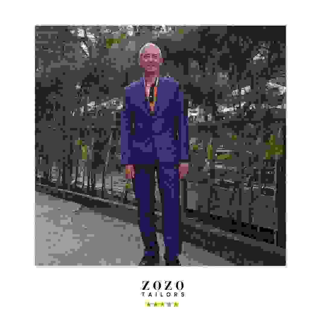 Person wearing a cobalt blue tailored suit for relaxed evenings out Person wearing a cobalt blue tailored suit for relaxed evenings out
