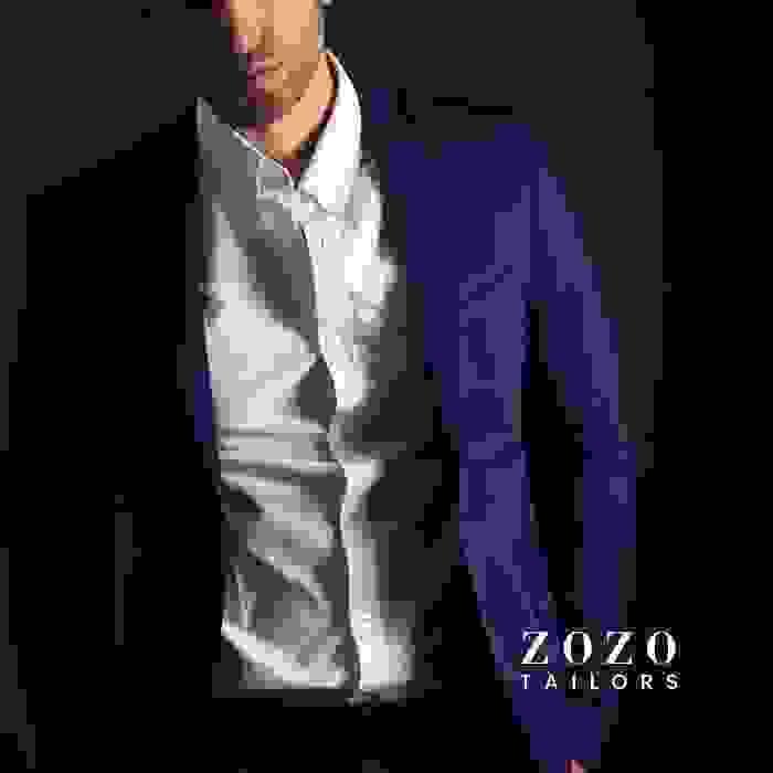 Professional man in custom-tailored jacket and crisp white shirt—demonstrating refined fit and style.