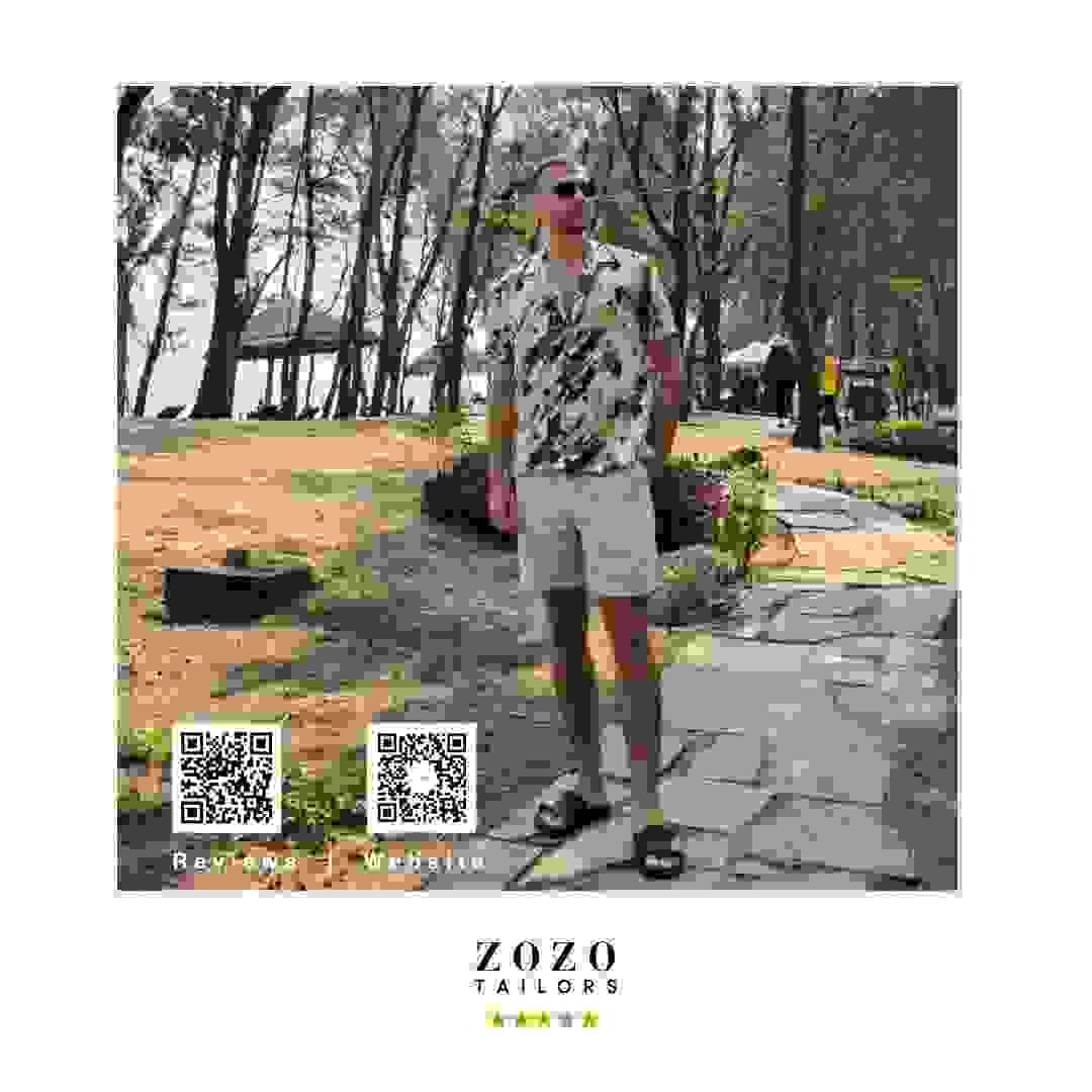 Person wearing patterned shirt with light tailored shorts for leisure wear Person wearing patterned shirt with light tailored shorts for leisure wear