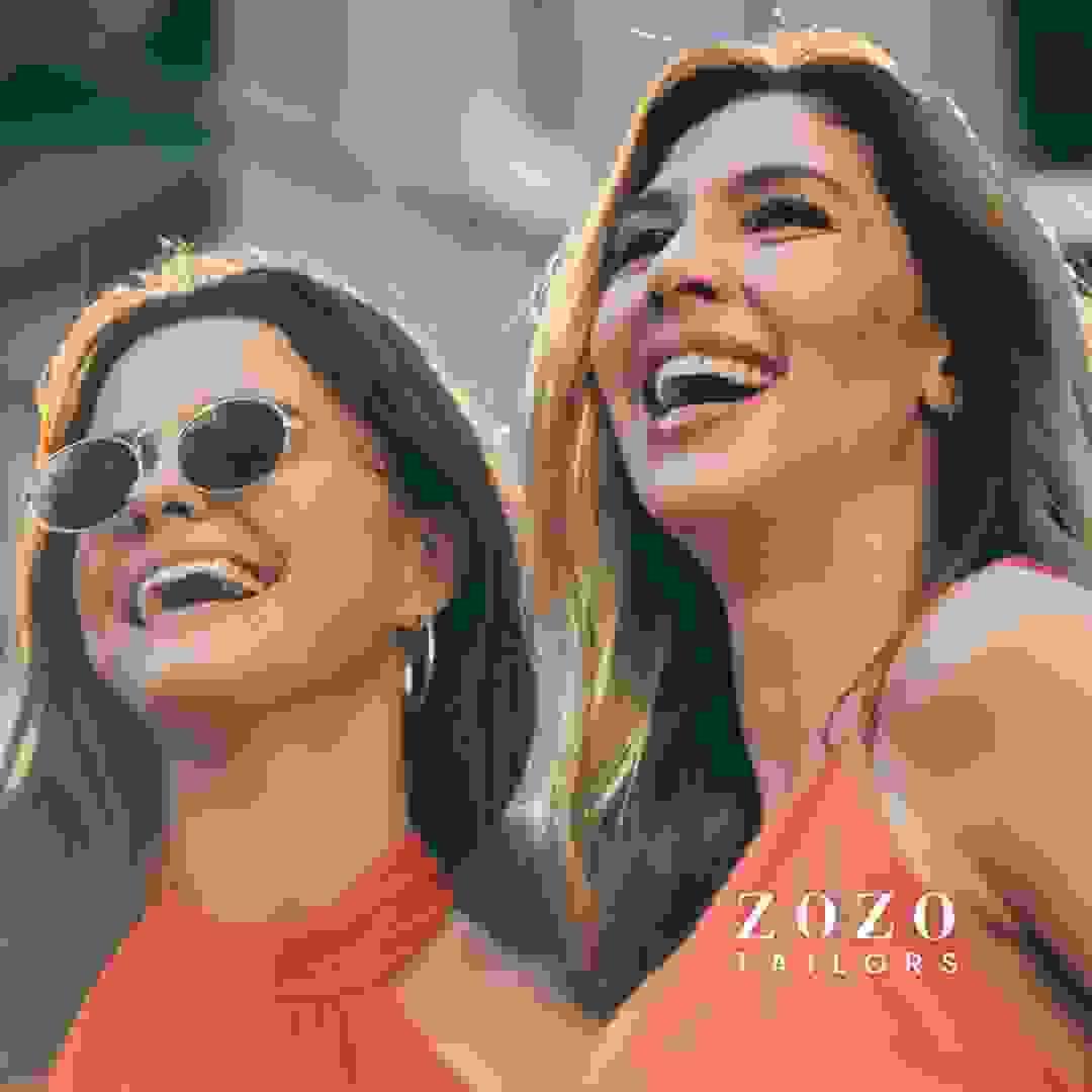 Two women in elegant cocktail dresses — enjoying their holiday with confidence in their personal style.