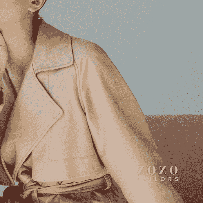 close up image of women's  coat-dress, showing lapels and fabric, with the caramel coloured fabric draping beautifully