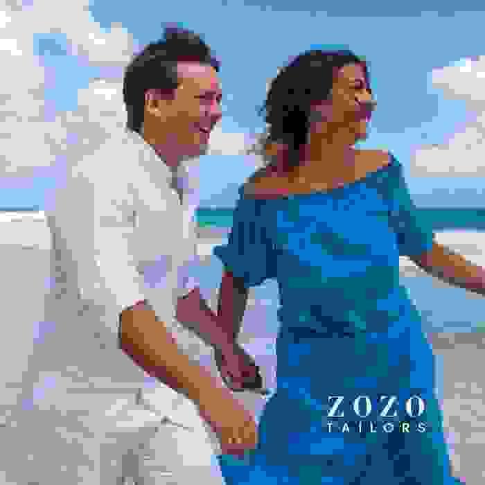 image of happy and stylish couple on vacation, cavorting in the shallow waters of the seaside location