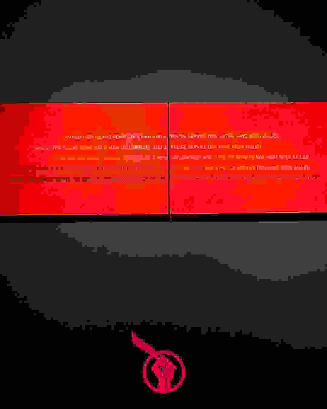 A graffitied roadside sign (black and yellow diagonal stripes) with the text “SINIXT” and “FTP.” A black and white Justice For Jared sticker is stuck in the centre. At the bottom of the graphic is the Justice For Jared logo, a red fist holding up an eagle feather. A graffitied roadside sign (black and yellow diagonal stripes) with the text “SINIXT” and “FTP.” A black and white Justice For Jared sticker is stuck in the centre. At the bottom of the graphic is the Justice For Jared logo, a red fist holding up an eagle feather.