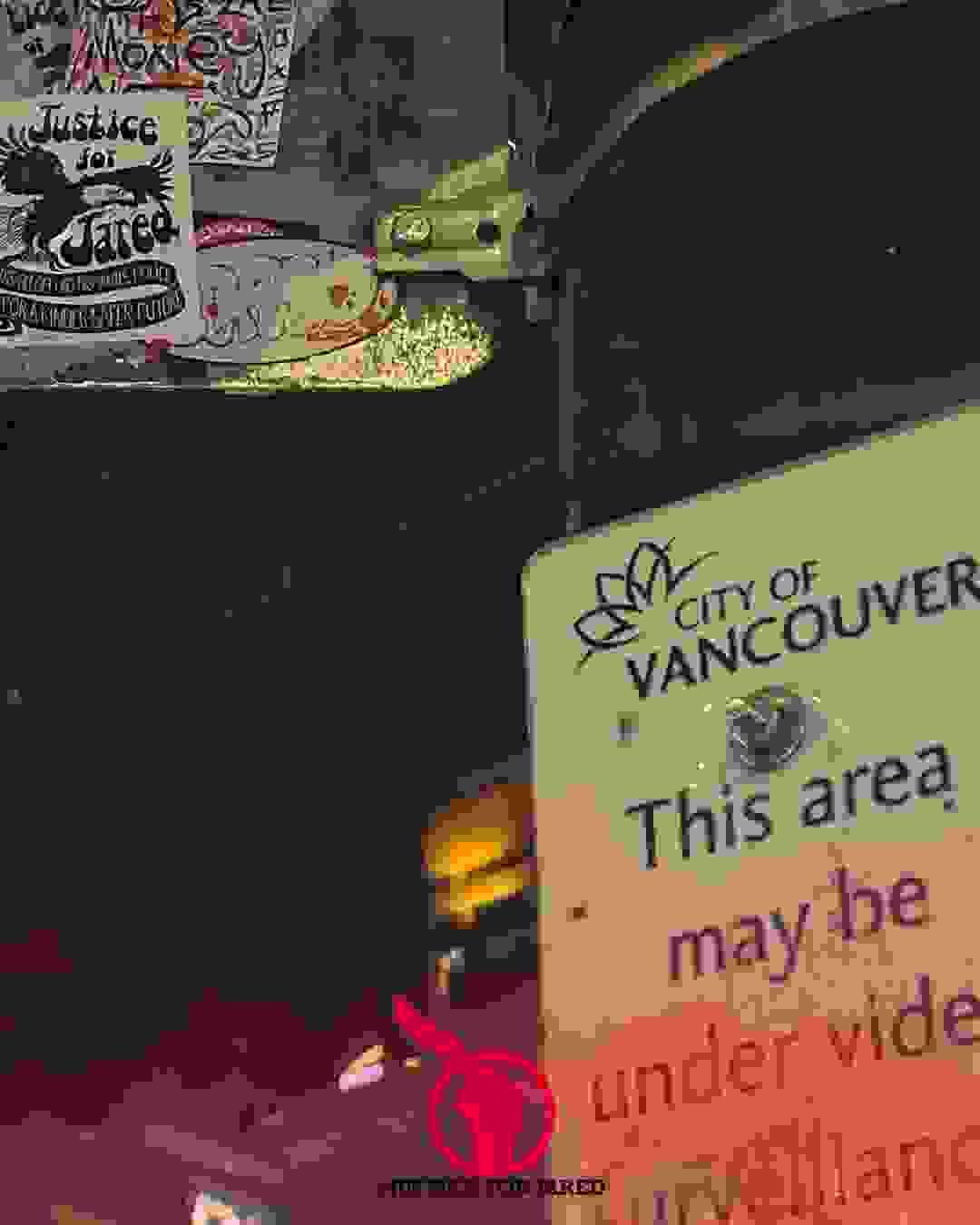 A Justice for Jared sticket on a sign above another sign that says "This area may be under video surveillance." A Justice for Jared sticket on a sign above another sign that says "This area may be under video surveillance."