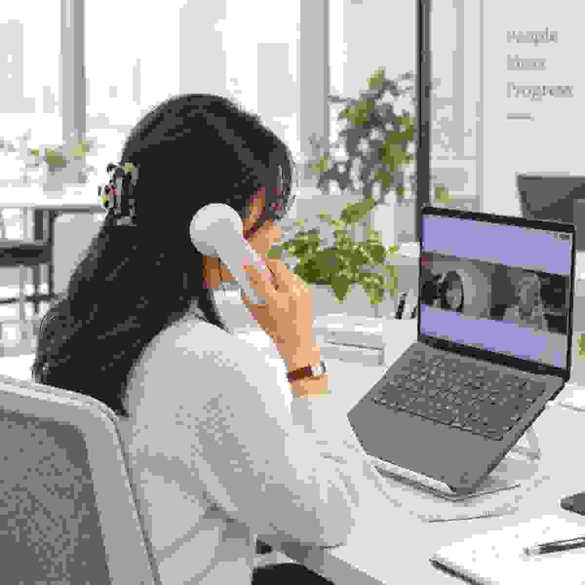 Retro phone handset used for office and remote work with a laptop Retro phone handset used for office and remote work with a laptop