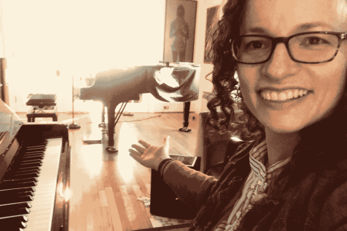 "The Piano Room" studio space includes a baby grand piano and an upright.