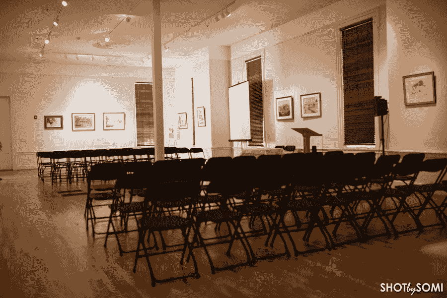 The main gallery of the Beach Institute with rows of folding chairs and a lectern.