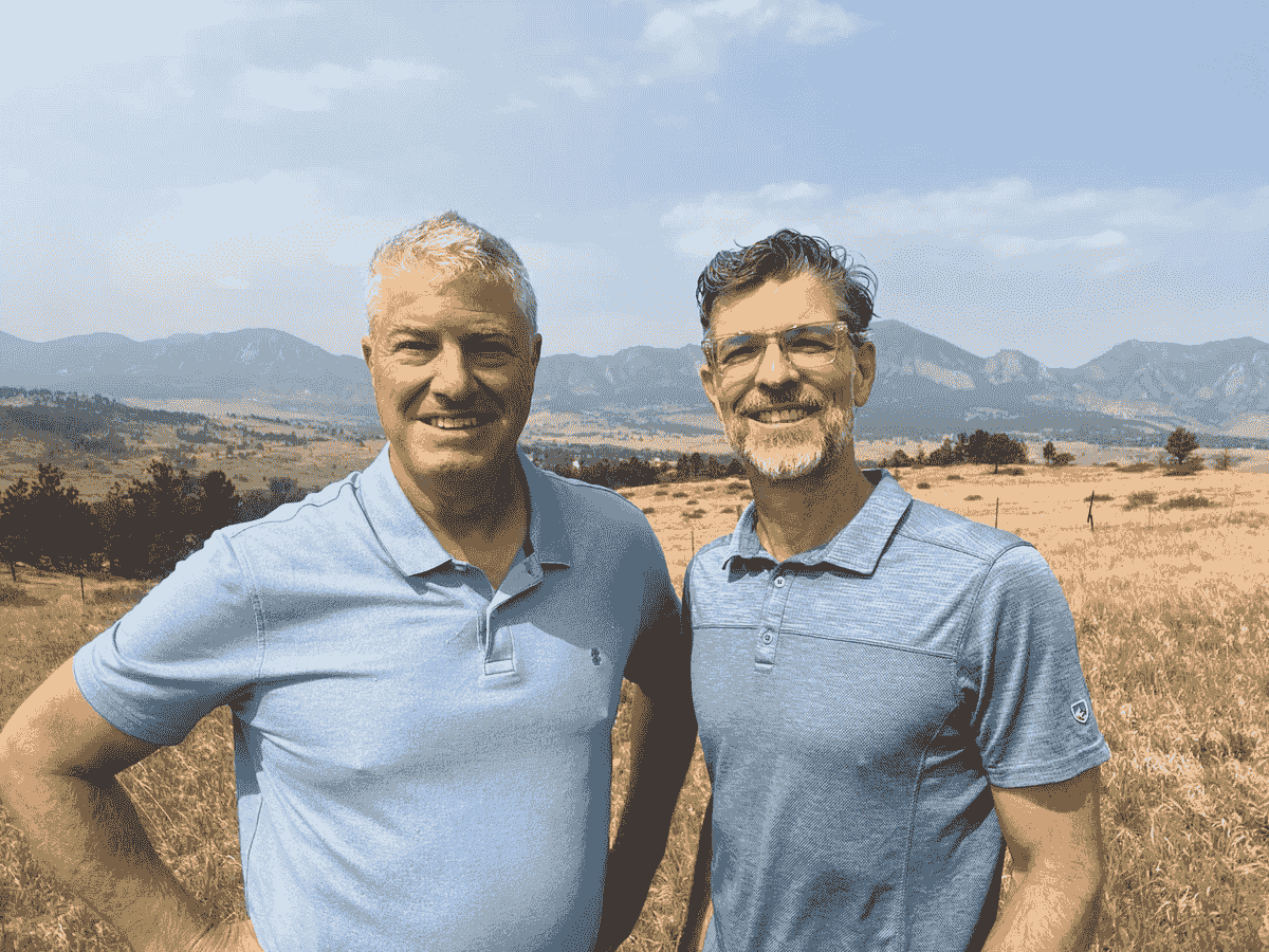 Jeff Caliguire and Jason Malec standing outside with mountains in the background Jeff Caliguire and Jason Malec standing outside with mountains in the background