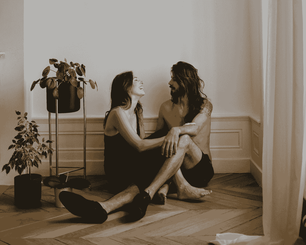 Couple holding each other on the floor Couple holding each other on the floor