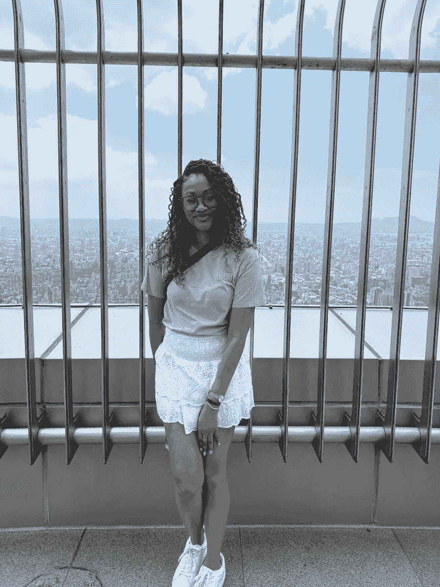 Brit Thompson standing in front of the edge of the Taipei 101 tower in Taipei, Taiwan
