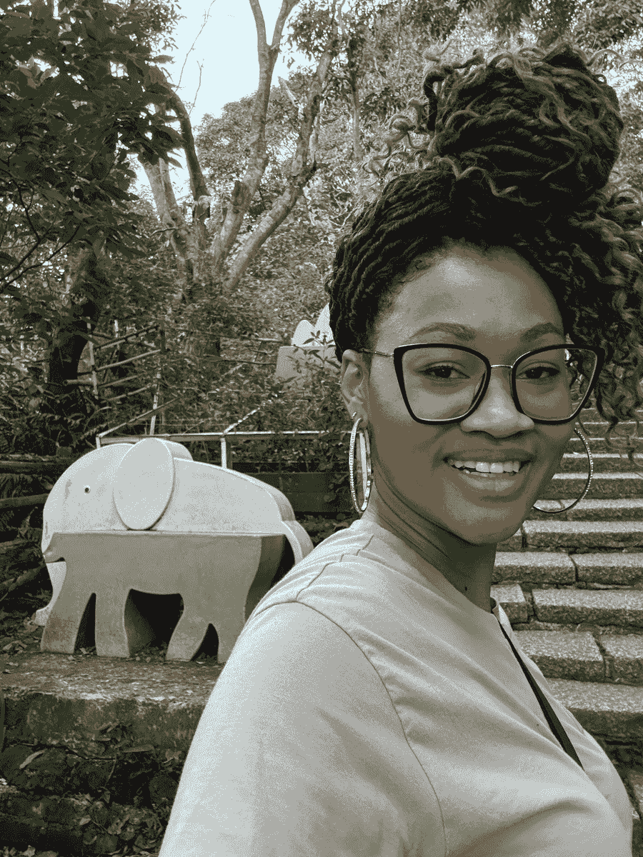 Selfie of Brit Thompson of Cultures Uncovered in front of the Elephant stairs entrance of Elephant Mountain hiking