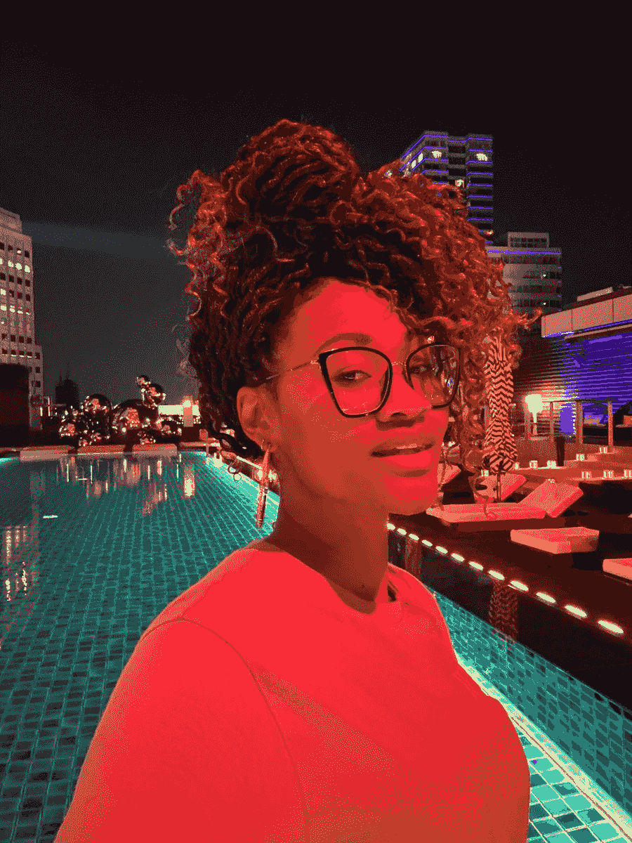 Brit Thompson in at the W Hotel Pool at night in neon lights