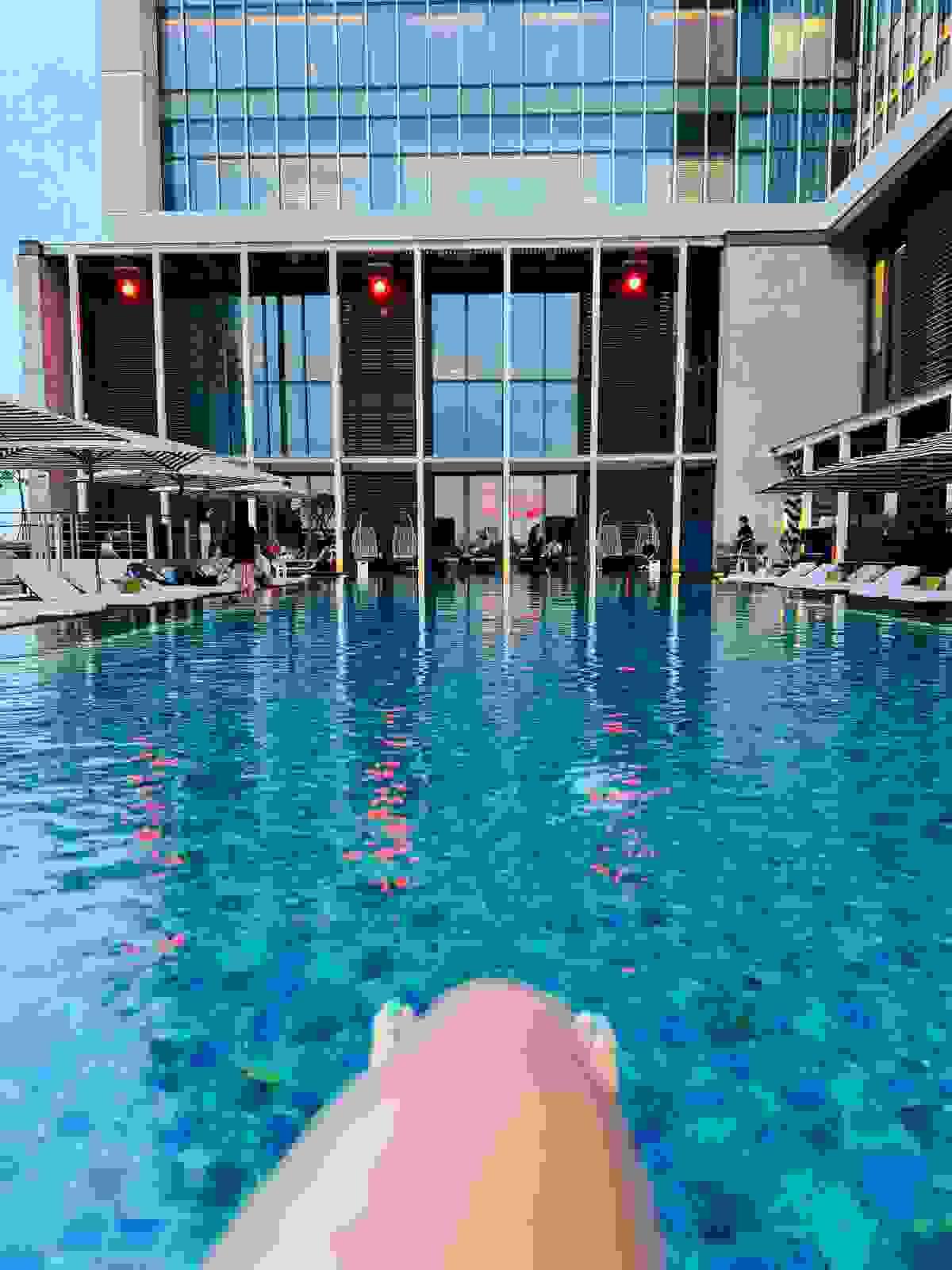 Brit Thompson legs at the ledge of the pool at the W Hotel Taipei in Taiwan