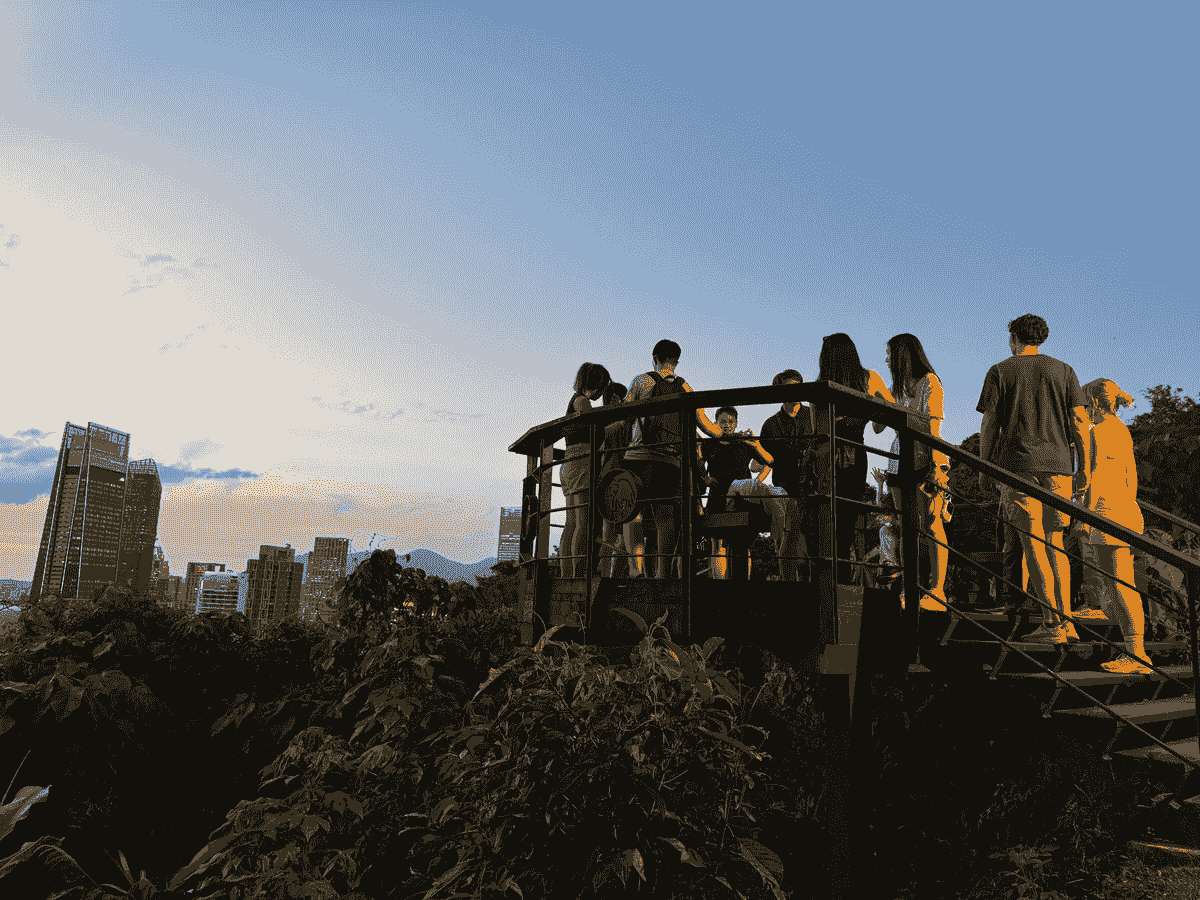 Stunning sunset skyline from the top of Elephant Mountain with a group of people on a landing