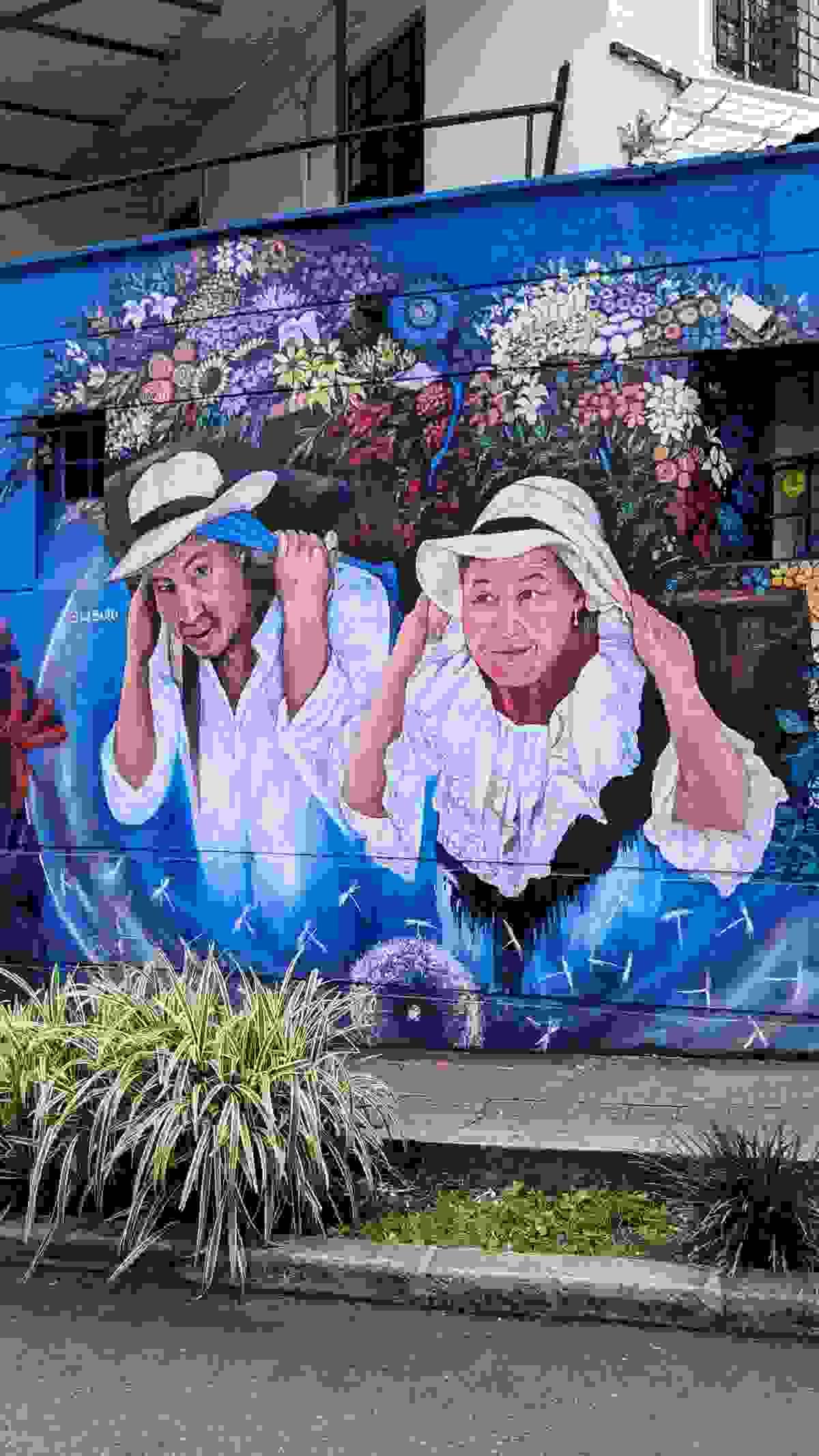 Street art of silleteros carrying flower arrangements during Medellín’s Feria de las Flores parade