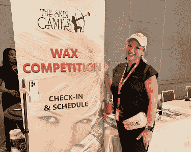 Brenda Hogsett at The Skin Games wax competition check-in, representing SKINTASTIC as an award-winning esthetician