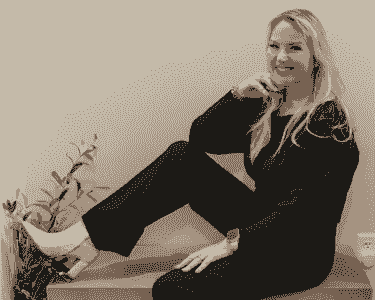   Brenda Hogsett of SKINTASTIC, Modesto esthetician and licensed skincare expert, sitting confidently in studio portrait