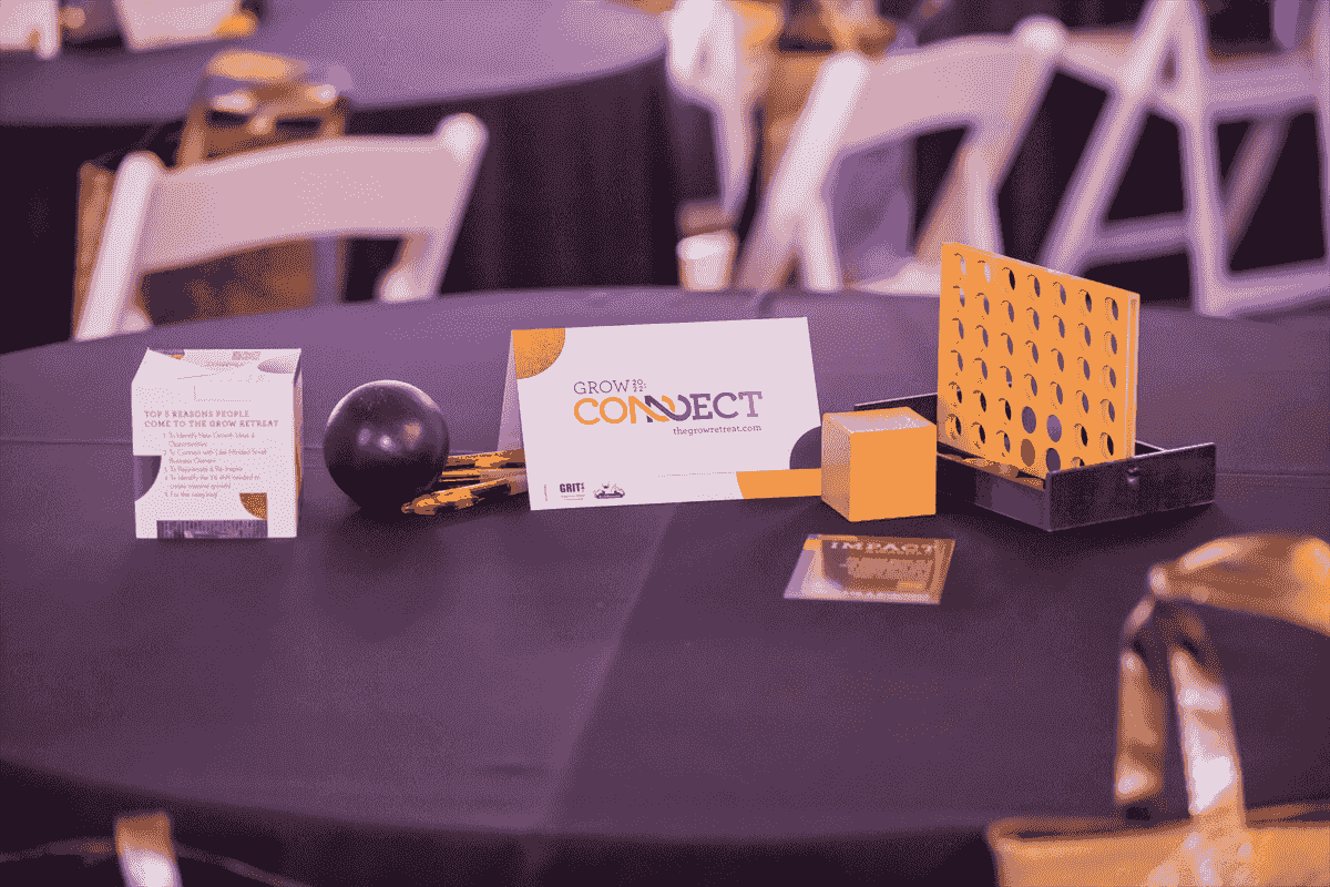 A table at the Grow Retreat displays the event theme Connect along with a connect 4 game and a ball.